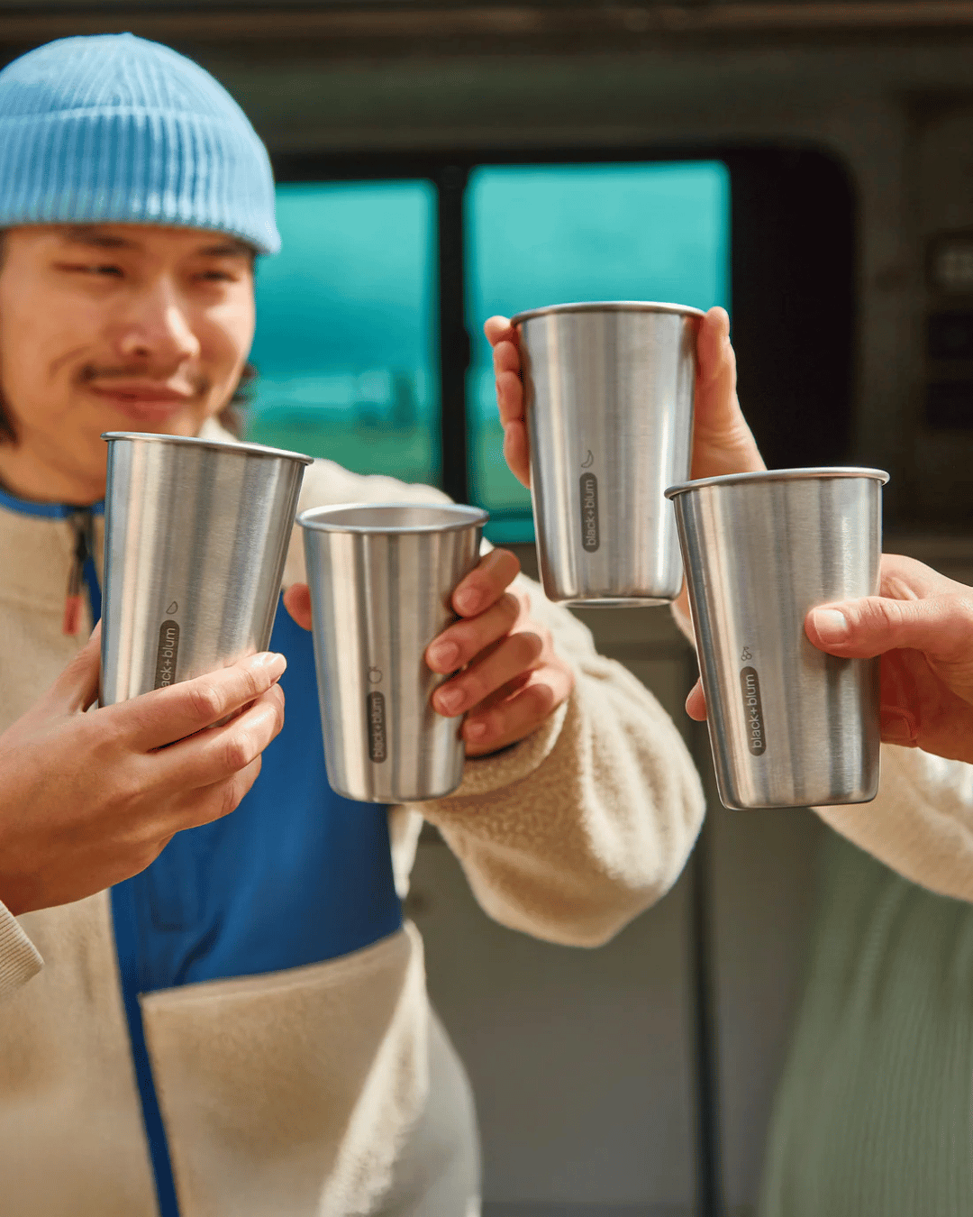Group of friends cheersing with the Black + Blum Stainless Steel  Tumblers