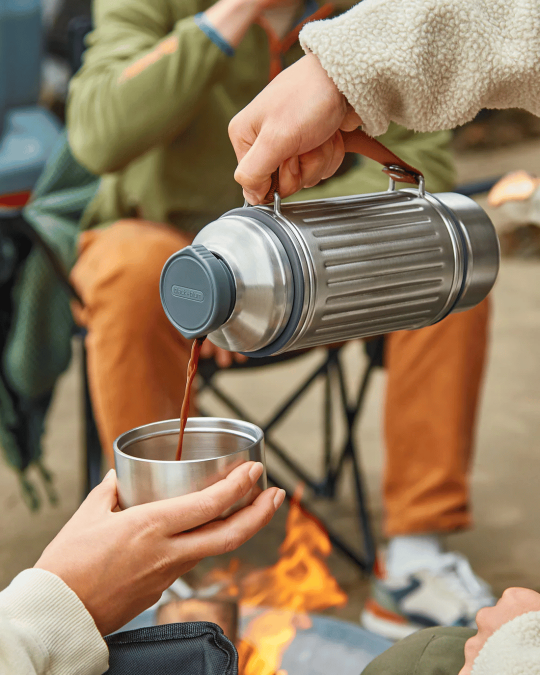 Pouring hot chocolate from the Black + Blum Flask, into one of the attachable cups