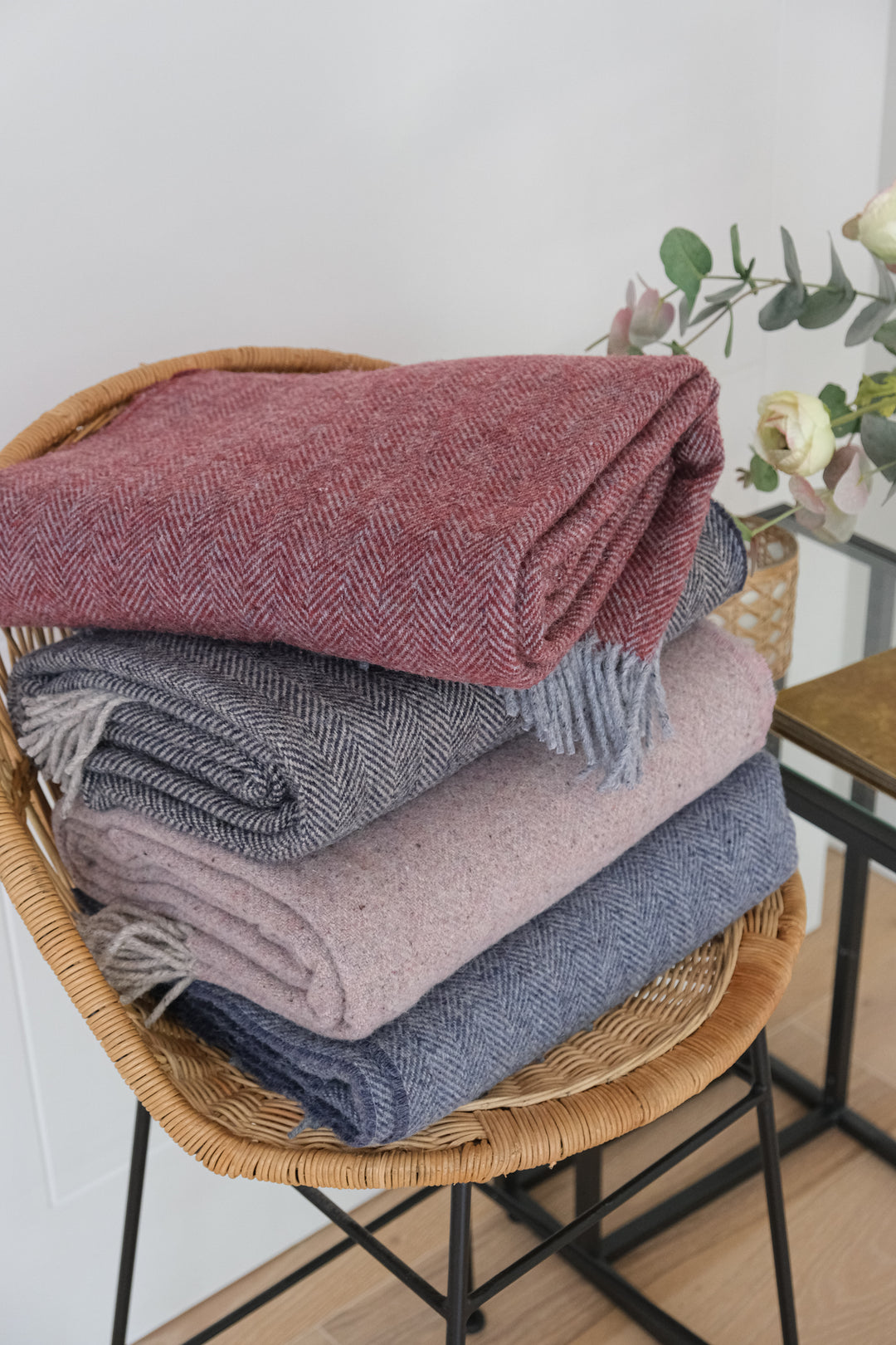 Stack of Cashmere and Merino Recycled Wool Blankets on a chair by Turtle Doves for The British Blanket Company