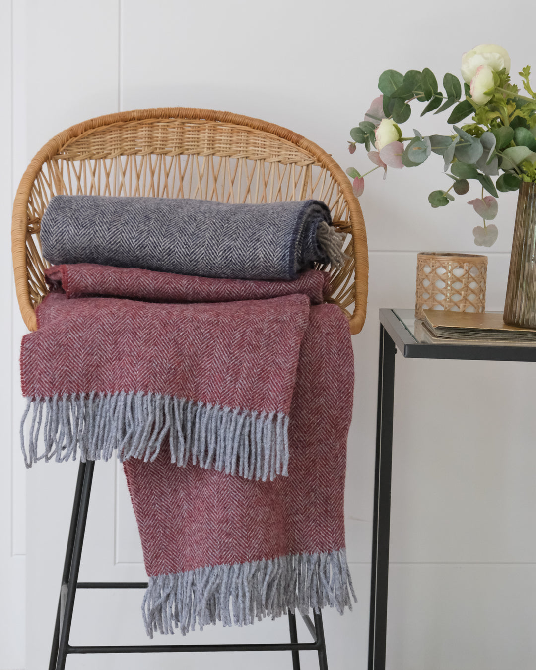 Stack of Cashmere and Merino Recycled Wool Blankets on a chair by Turtle Doves for The British Blanket Company