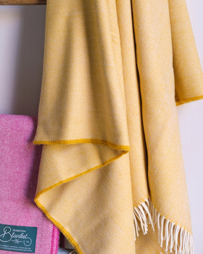 yellow merino wool throws hanging on a ladder from The British Blanket Company