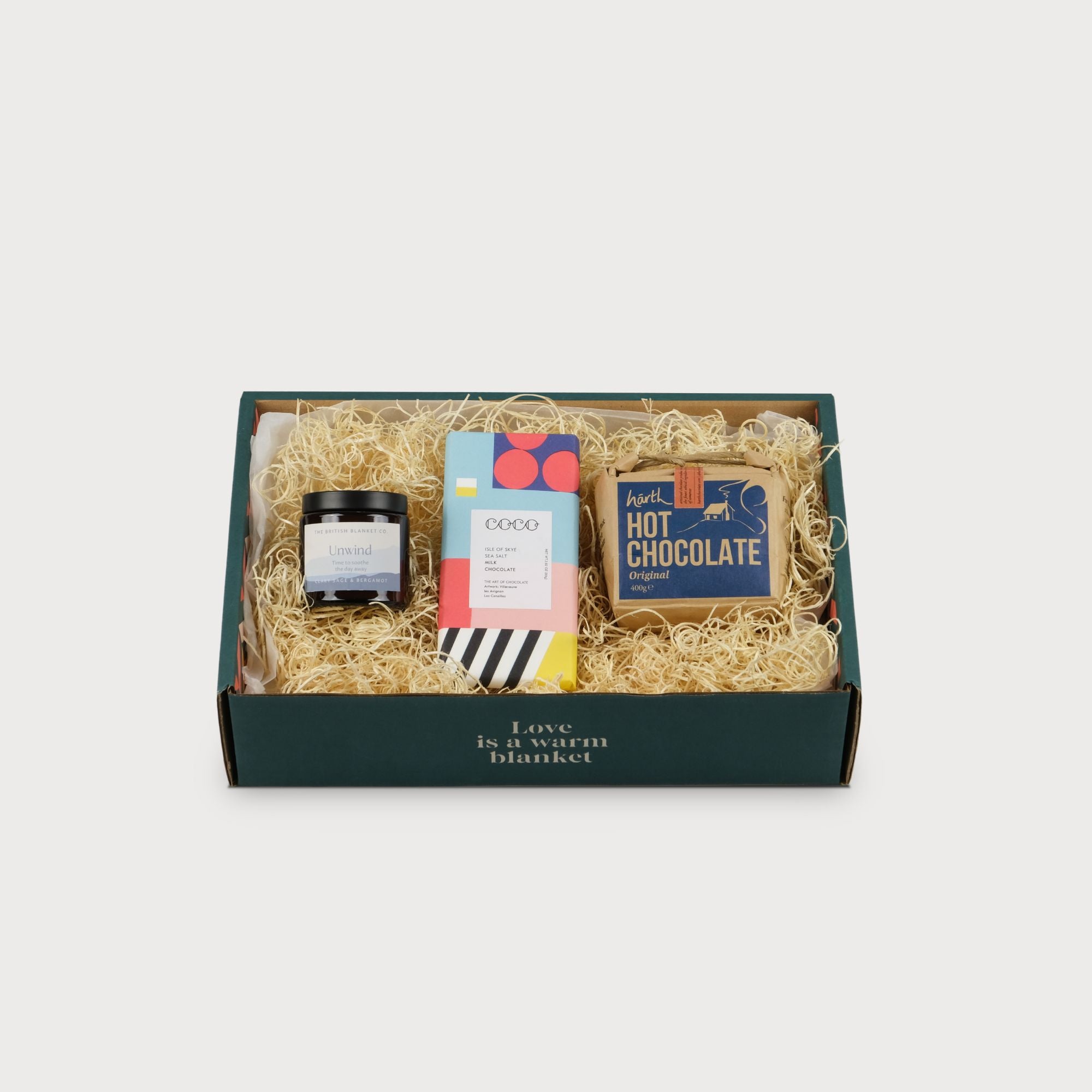 Cosy Gift Box: Winter featuring a candy bar and hot chocolate, packaged in a distinctive black and white striped container.