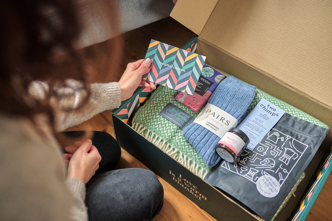 Gift Recipient opening Cosy Blanket Gift Boxes from The British Blanket Company