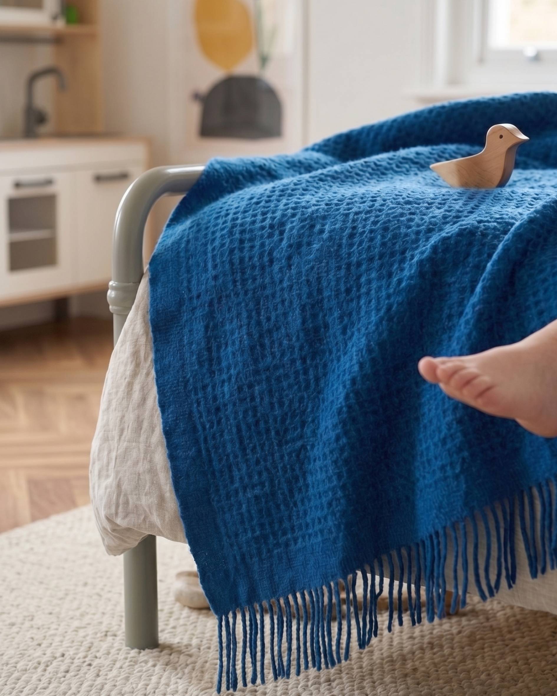Dark blue waffle blanket in a childs bedroom