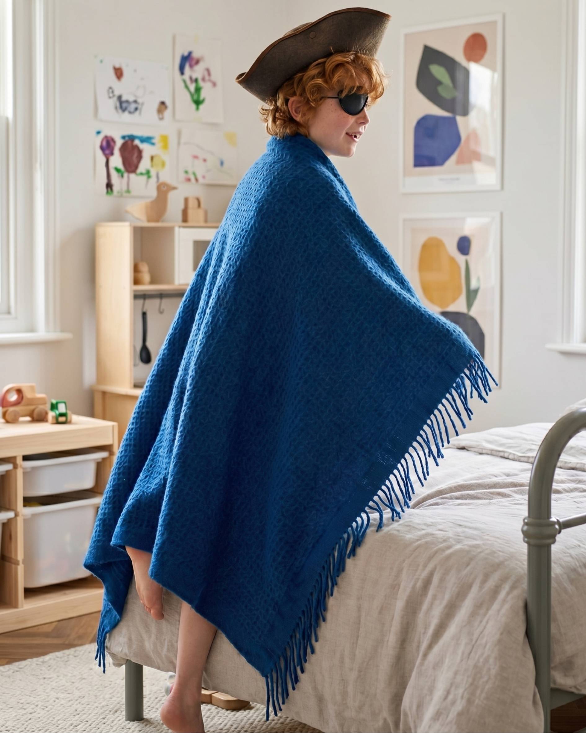 Young boy playing pirate in his bedroom with the Dark blue waffle Blanket