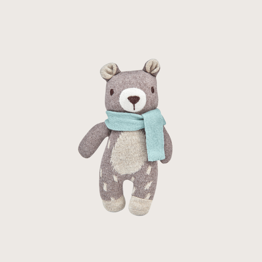 Knitted teddy bear in mottled brown-and-cream yarn with a light blue scarf, part of the Cloud Cotton Baby Blanket Gift Box: Boatyard Glow.