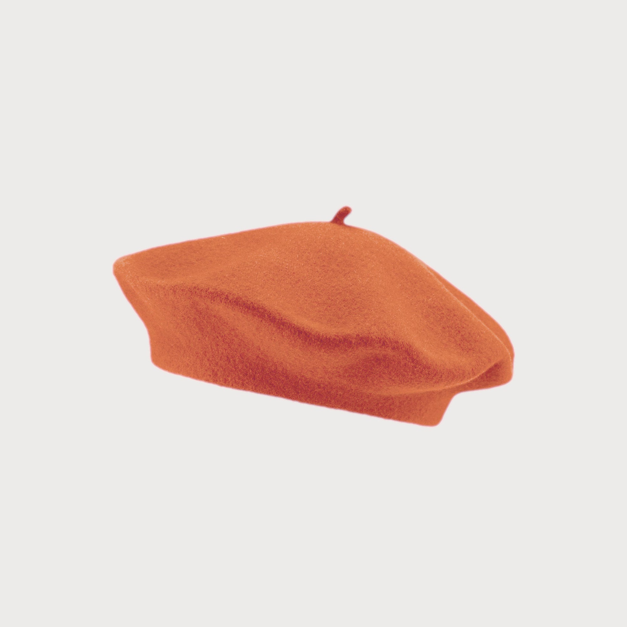 Orange wool beret, flat-crowned with a stalk, offers warmth and breathability; fits most adults with a max inner circumference of 58cm.