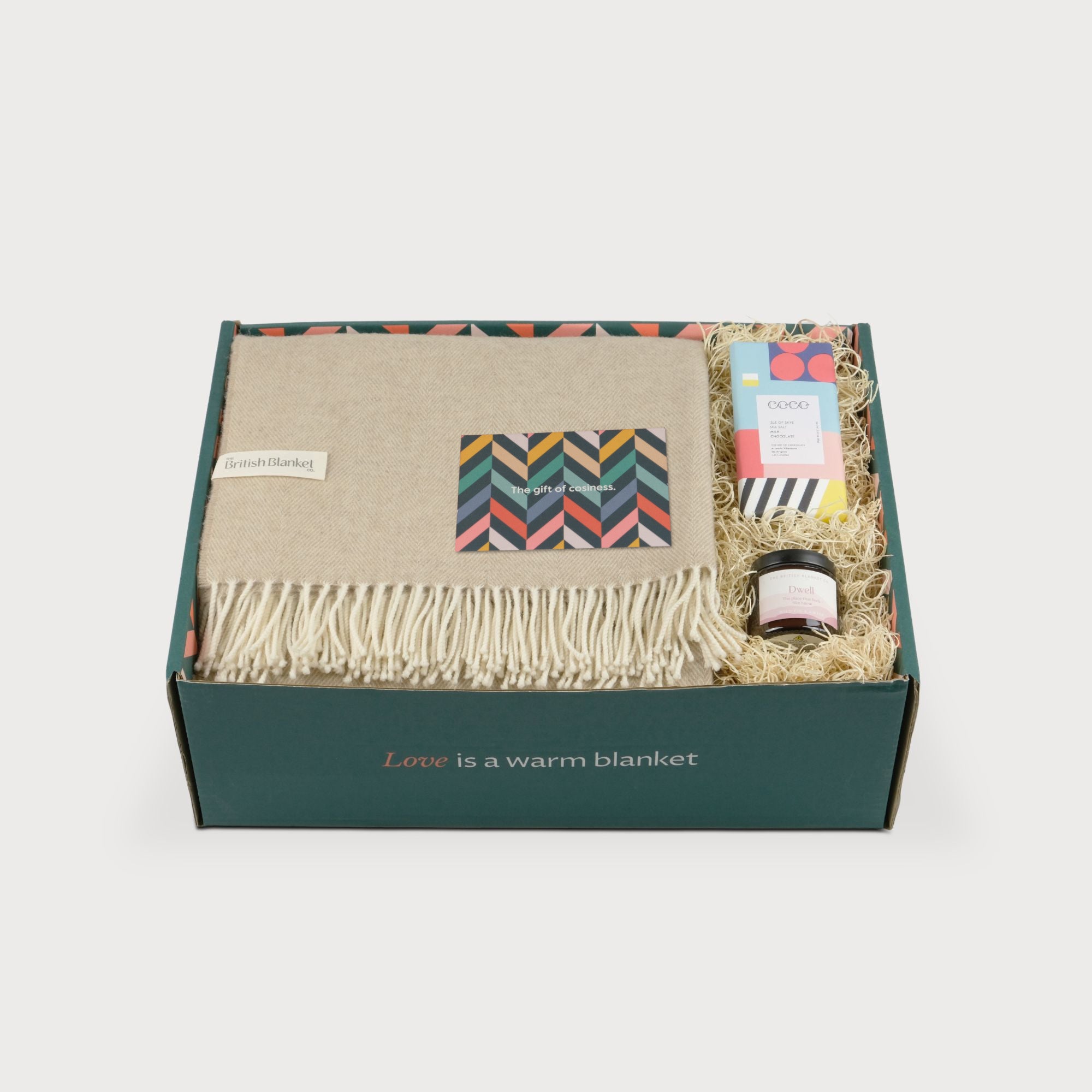 Merino Blanket Gift Box: Basswood includes a fringed wool blanket, greeting card, COCO chocolate, and Dwell candle, all nestled in a Love is a warm blanket box.