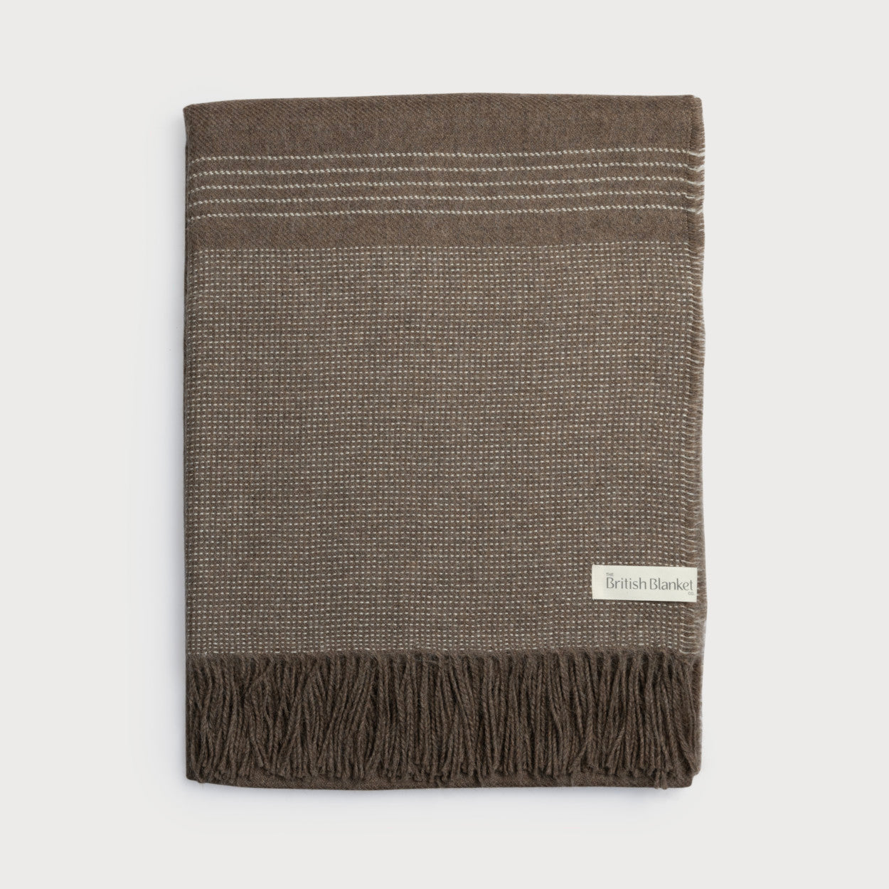 Taupe-brown Alpaca Blanket with white-stitch pattern, narrow stripes, and fringe. Label reads “British Blanket”. Part of the Alpaca Blanket Gift Box: Mocha Brown.