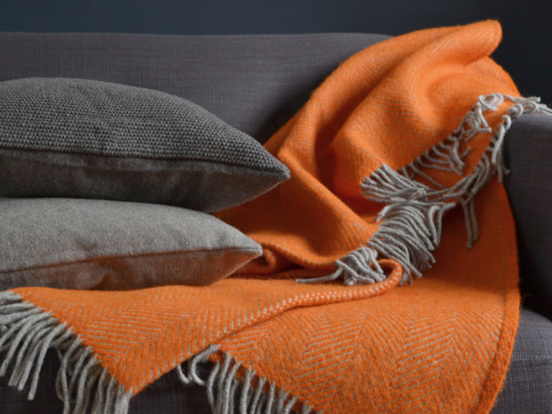 orange wool blanket on a chair