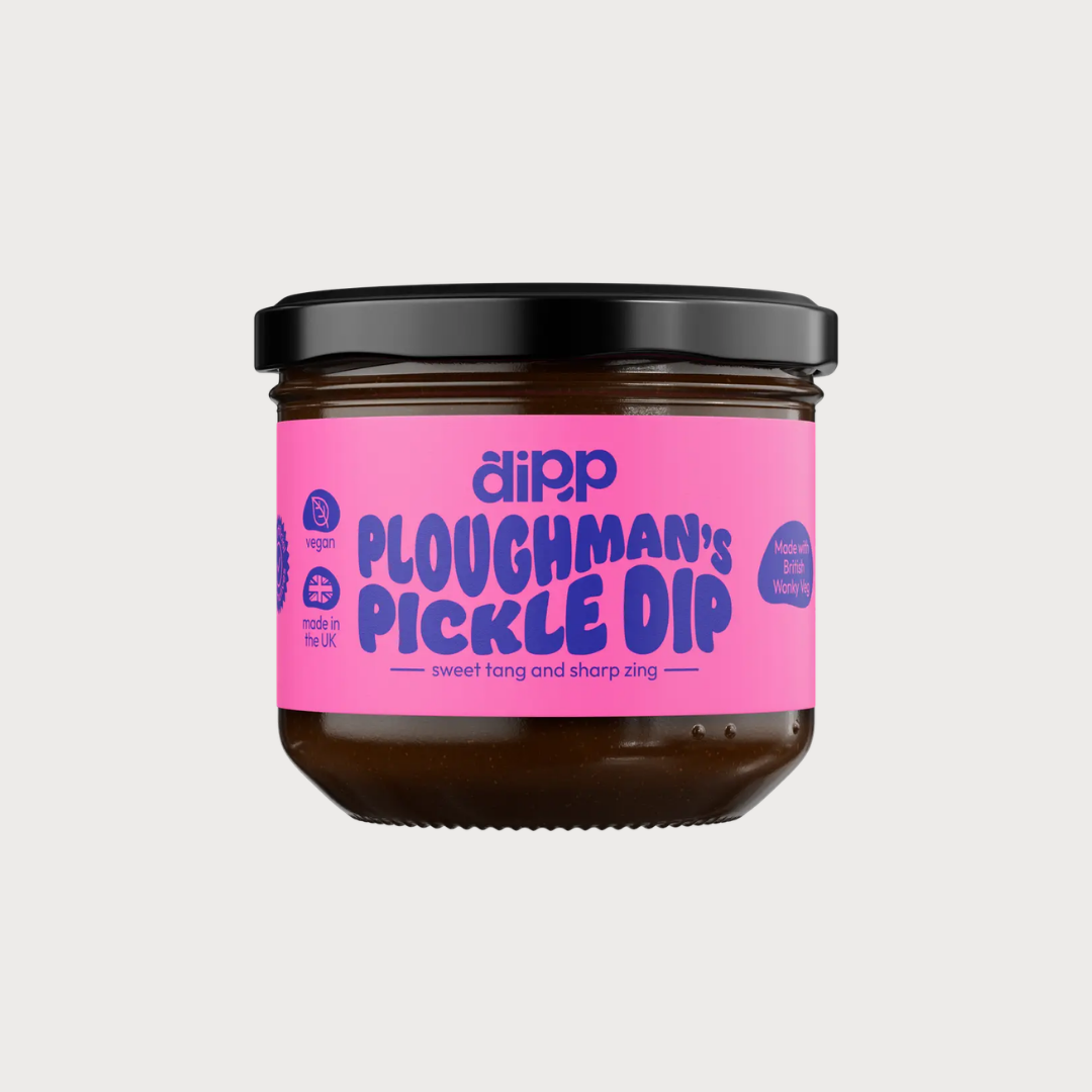 Jar of dipp Ploughman's Pickle Dip, featuring a sweet-tangy, sharp-zing vegan pickle dip made in the UK, highlighted by its distinctive pink label.