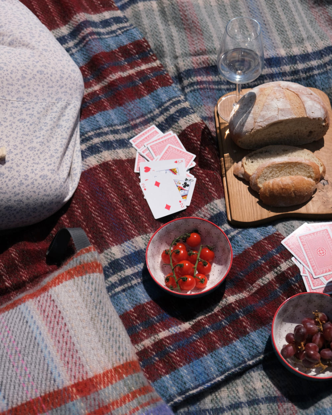 People having a picnic and playing cards in the park
