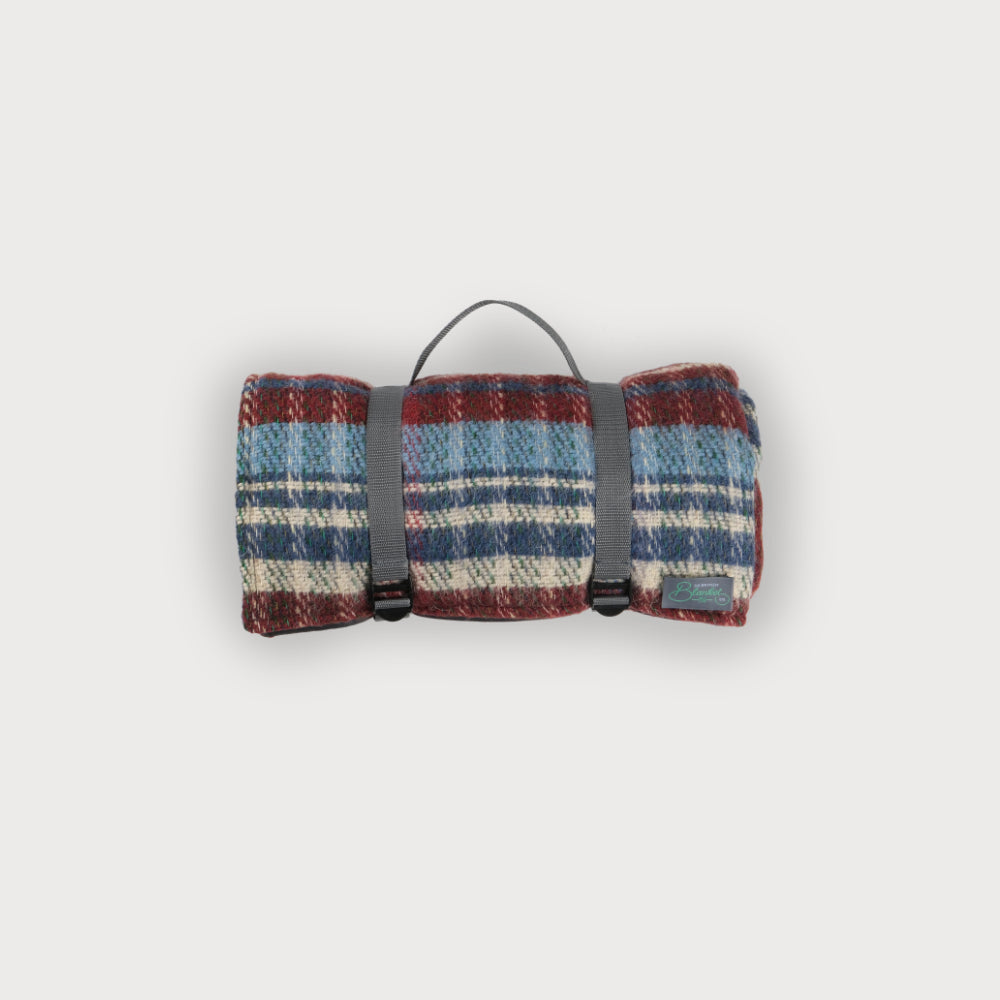 Rolled random recycled picnic blanket with short carry strap