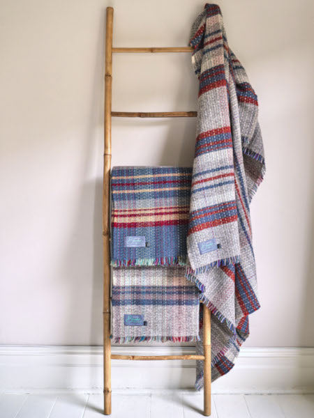 random recycled rugs from The British Blanket Company draped on a ladder