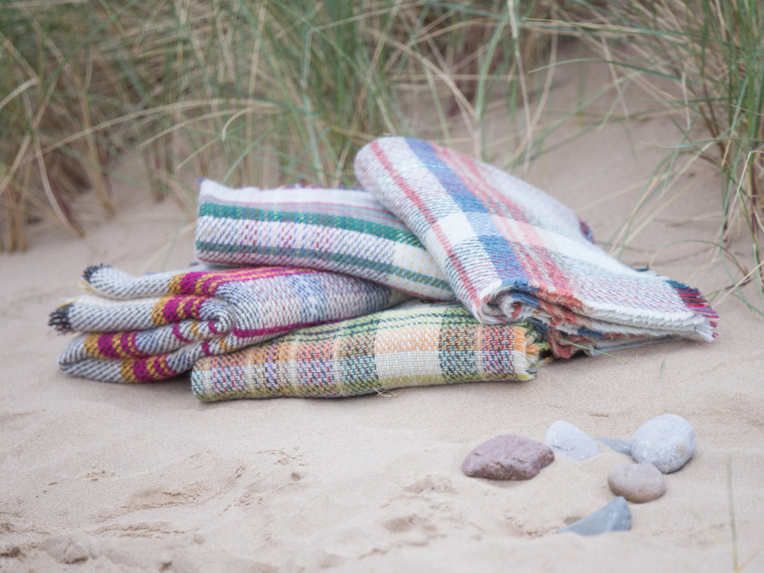 on the beach stack of Random recycled wool throw blanket - The British Blanket Company