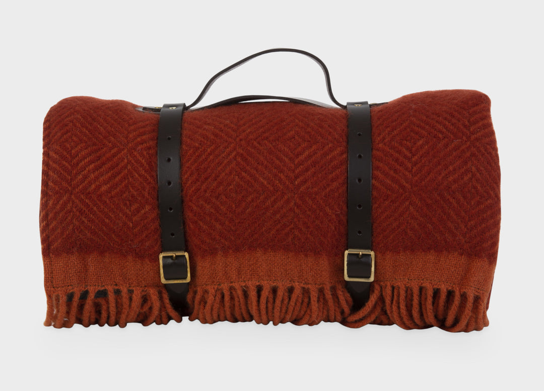 Red wool picnic blanket with leather straps from The British Blanket Company