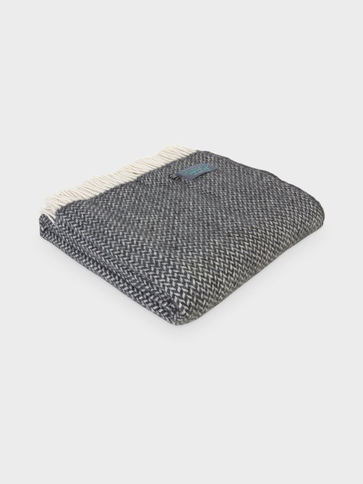 A folded grey herringbone wool throw by The British Blanket Company.