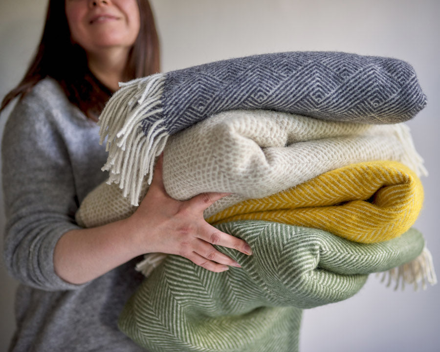 Stack of pure wool blanket throws from The British Blanket Company
