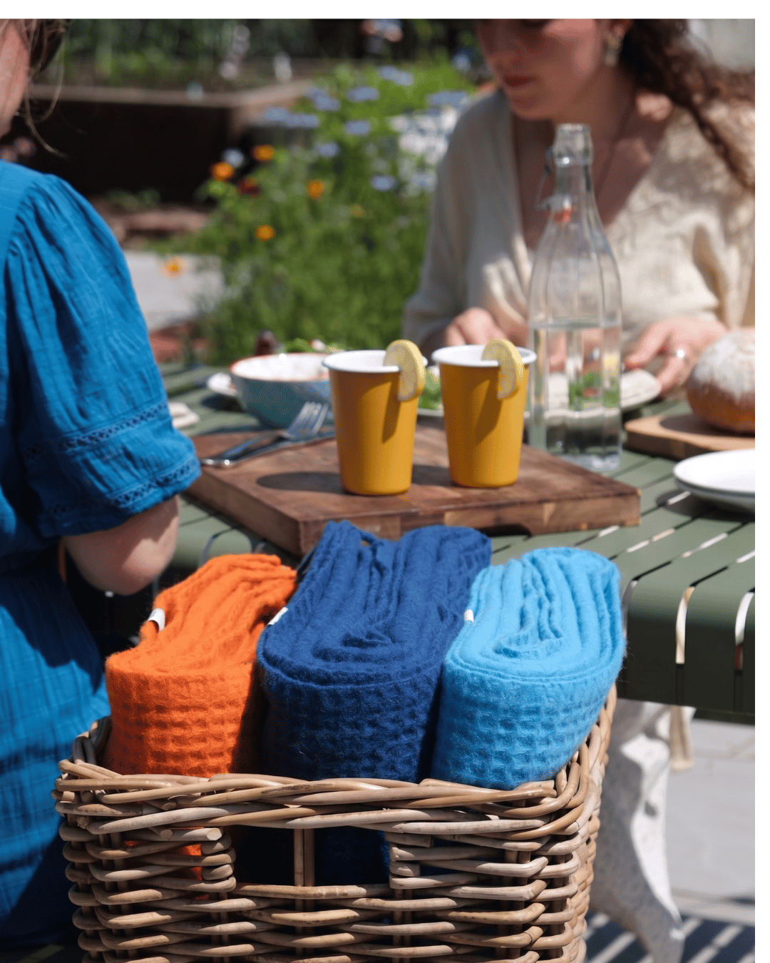 Outdoor summer garden lunch with Falcon enamel mustard tumblers and British Blankets