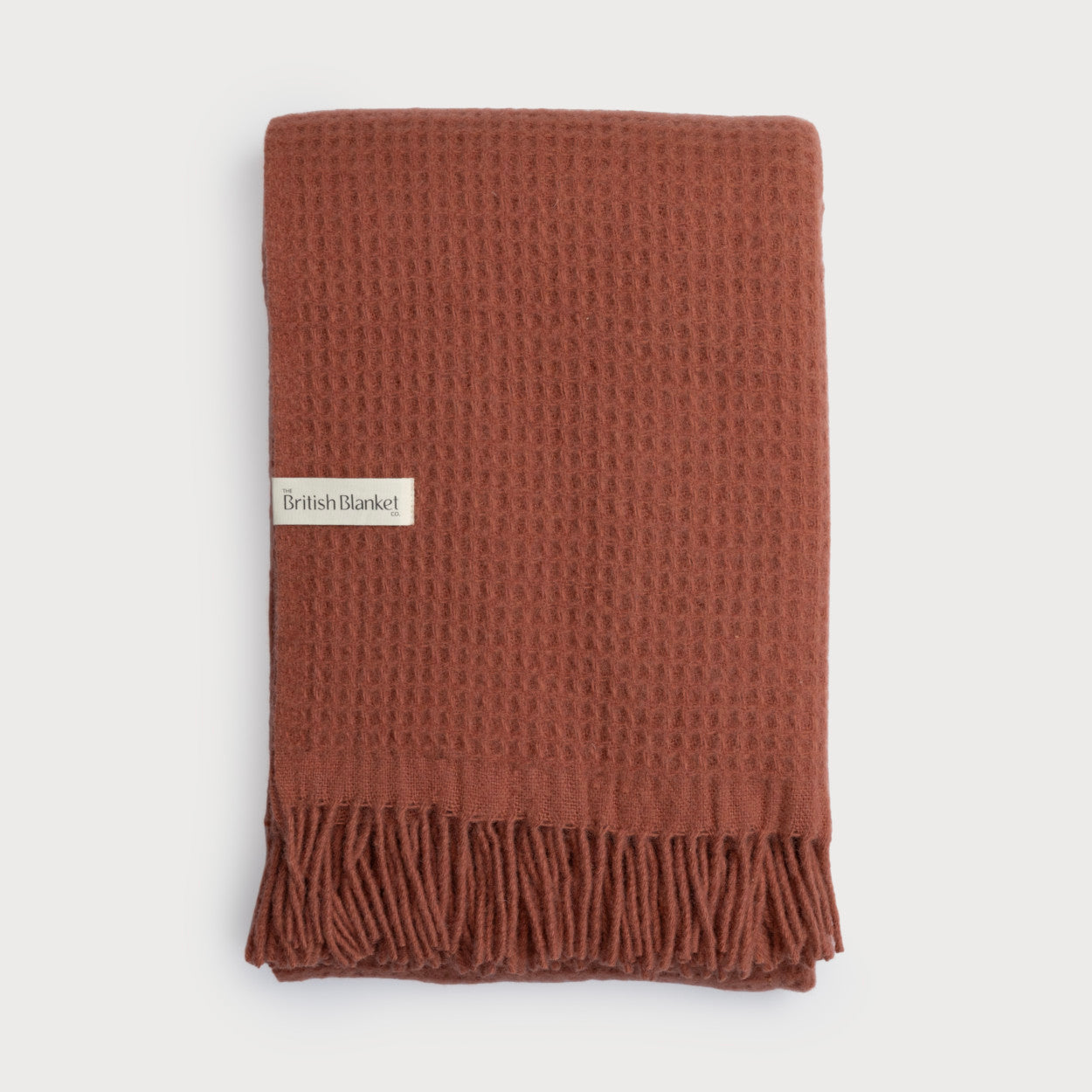 The Totterdown Waffle Blanket: Brunswick (C) features a textured waffle weave and fringed ends, with a label from The British Blanket Co.