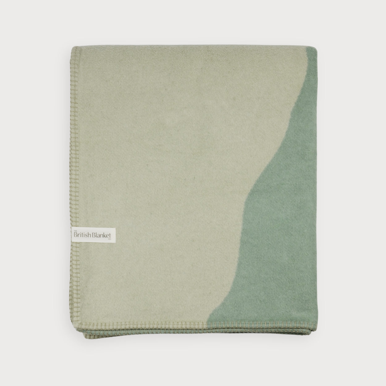 Cloud Cotton Blanket: Vale in Thyme, featuring muted green tones, abstract design, and whip-stitched edges. Made from recycled cotton, embodying timeless modernity.