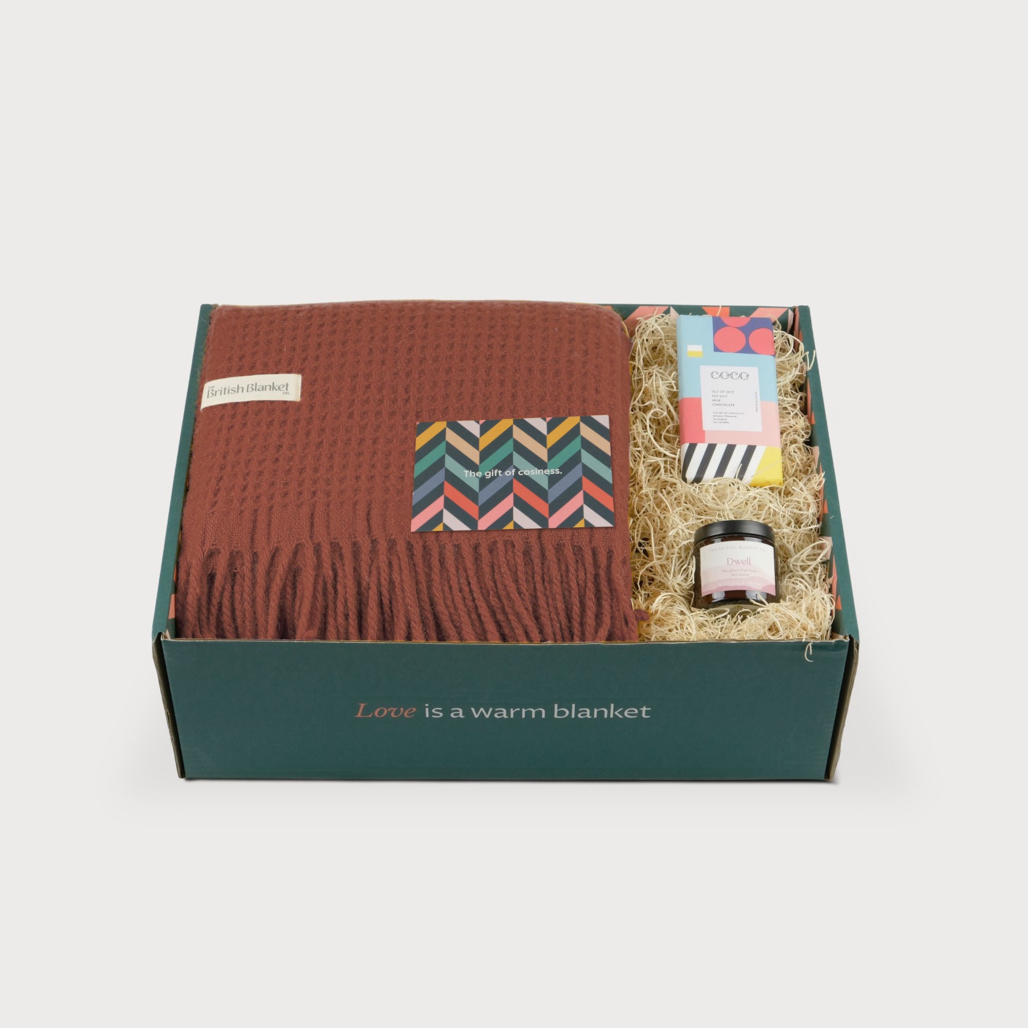 Totterdown Blanket Gift Box: Brunswick, featuring a waffle-weave blanket, COCO chocolate, Dwell jar, and a cosiness-themed gift card in a green box.
