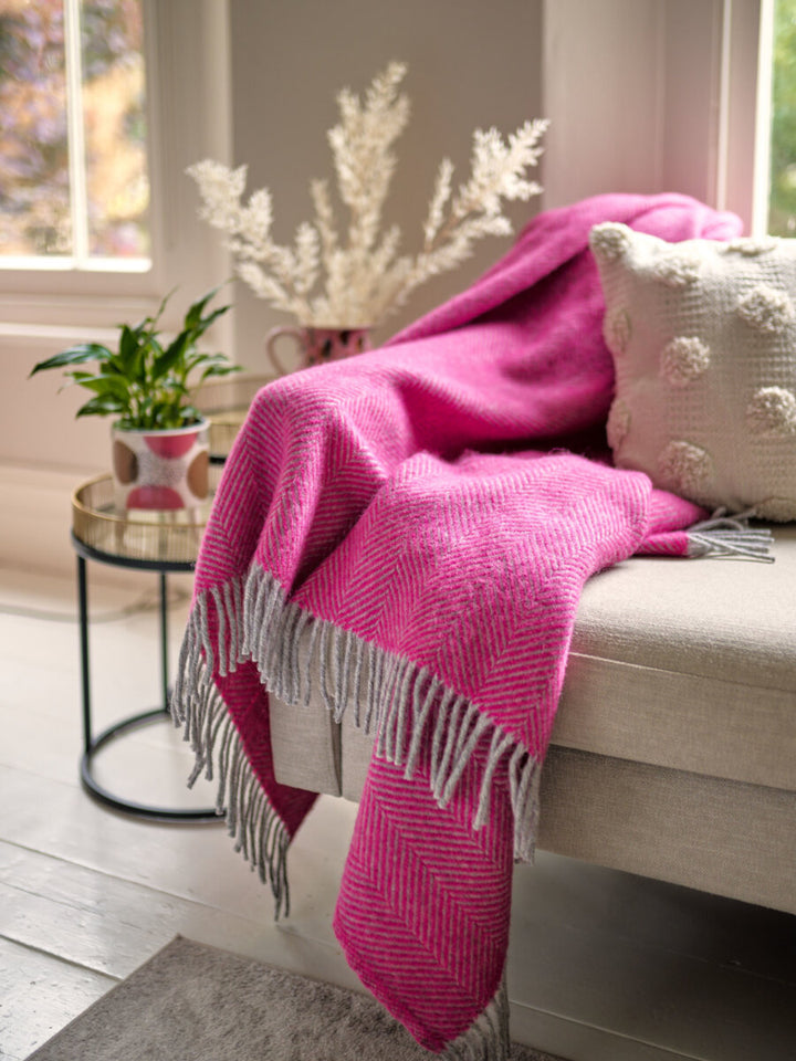 beige sofa styled with Bright Pink and Grey Herringbone Throw by The British Blanket Company