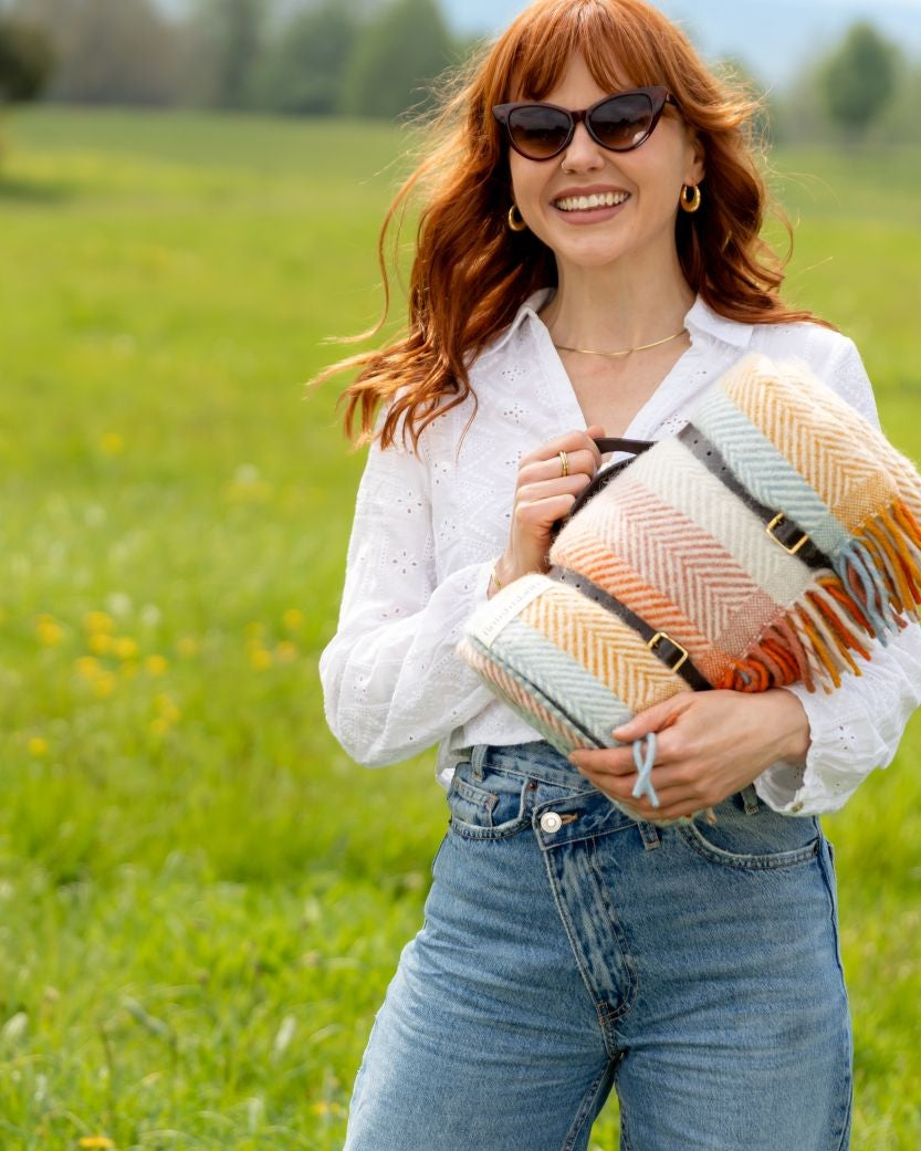 Waterproof Picnic Blanket: Boho, featuring a wool surface with stripes, waterproof backing, and leather straps, ideal for outdoor use and gifting. Handmade in the UK.