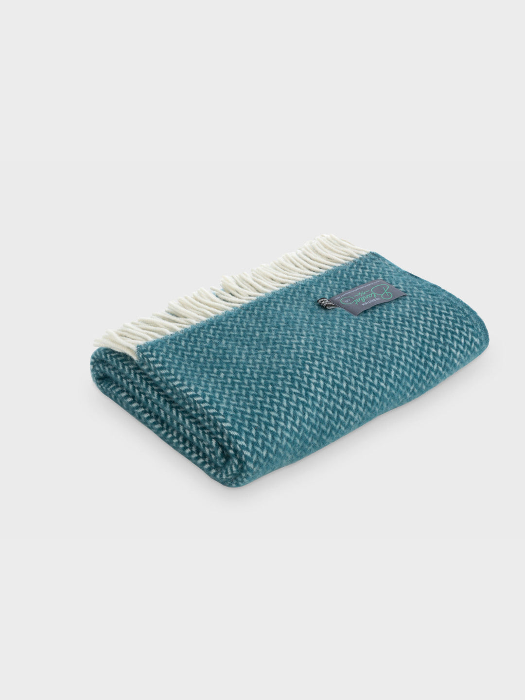A folded green herringbone wool blanket by The British Blanket Company.