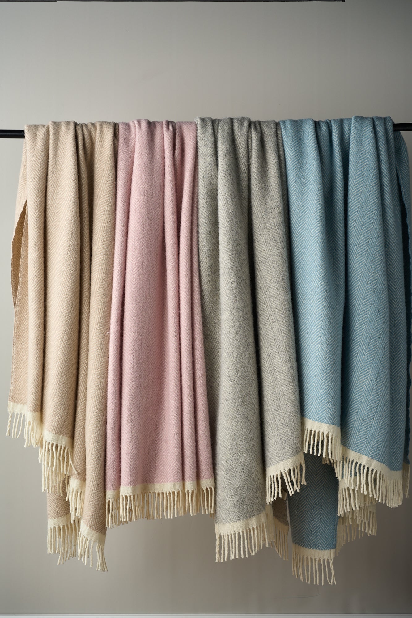 Herringbone wool blankets Clifton collection draped on a bar