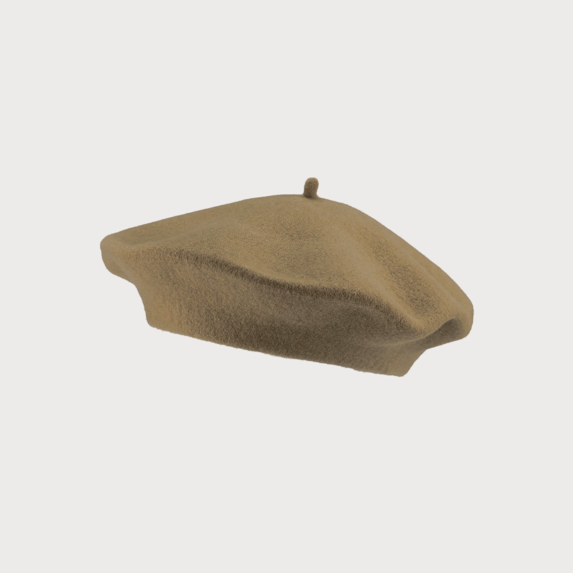 Wool Beret Hat: Camel Brown, viewed from the side, showcasing its thick felt construction, offering warmth and a classic Parisian-inspired style. One-size fits most adults.