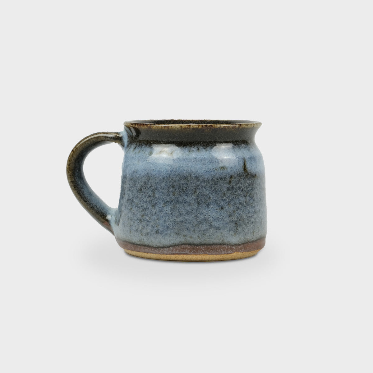 Cosy Gift Box: Night In features close-ups of earthenware pottery, highlighting the intricate details of a ceramic mug and handle, perfect for a relaxing evening.