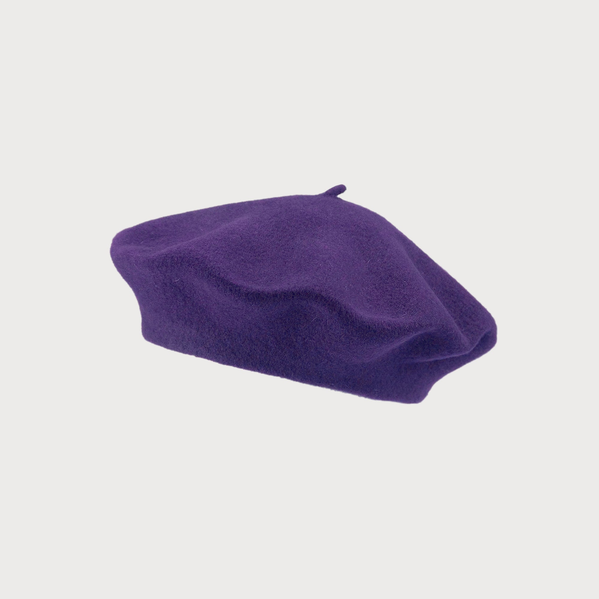 Wool Beret Hat: Purple, expertly knitted and hand-felted for shape retention, offers thicker, breathable warmth. Maximum circumference is 58cm.