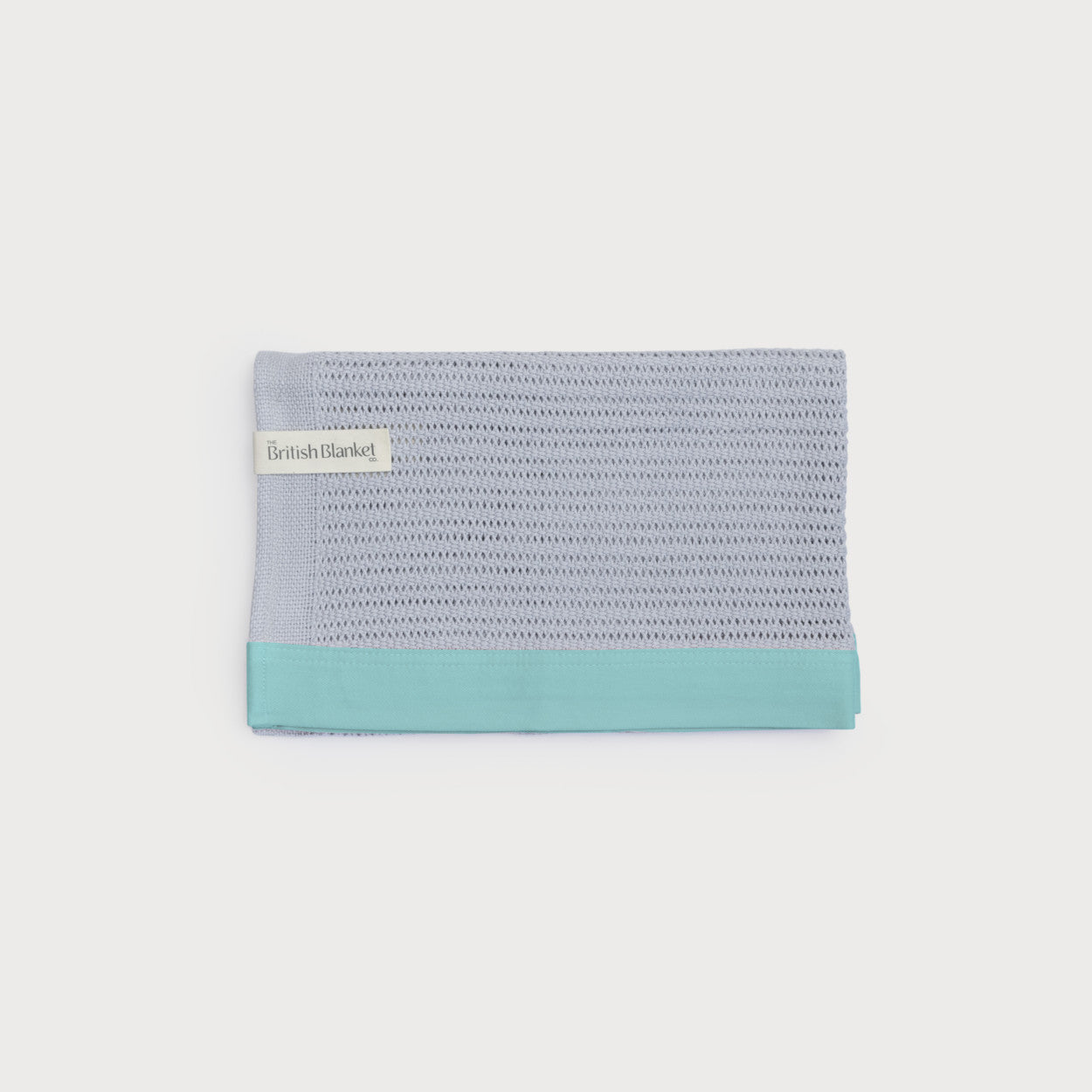 Organic Cotton Cellular Baby Blanket in Turquoise and Grey, showcasing its breathable, knitted texture with a contemporary cotton trim, ideal for regulating a baby's temperature.