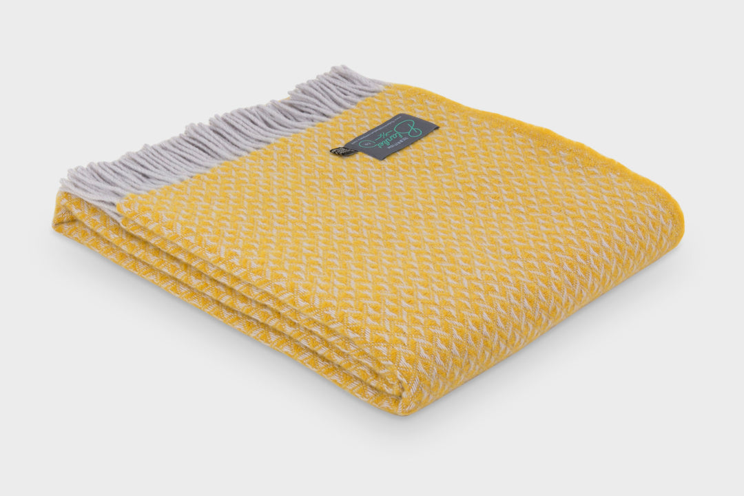 Folded large yellow diamond wool throw by The British Blanket Company