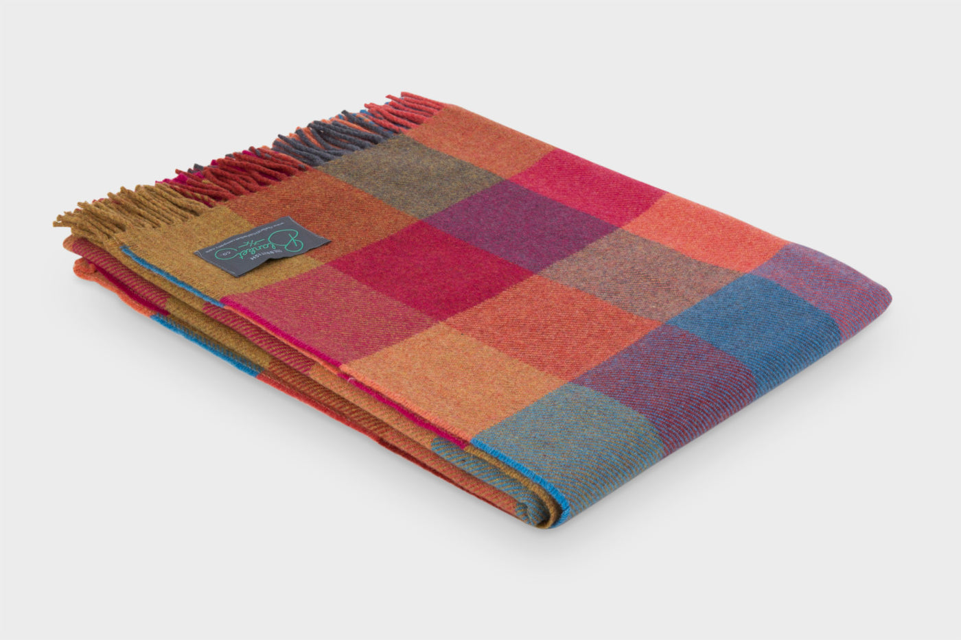 Folded multicoloured wool throw by The British Blanket Company