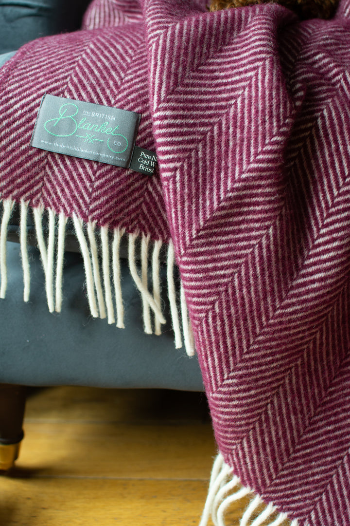 Closeup of a burgundy herringbone wool throw by The British Blanket Company.