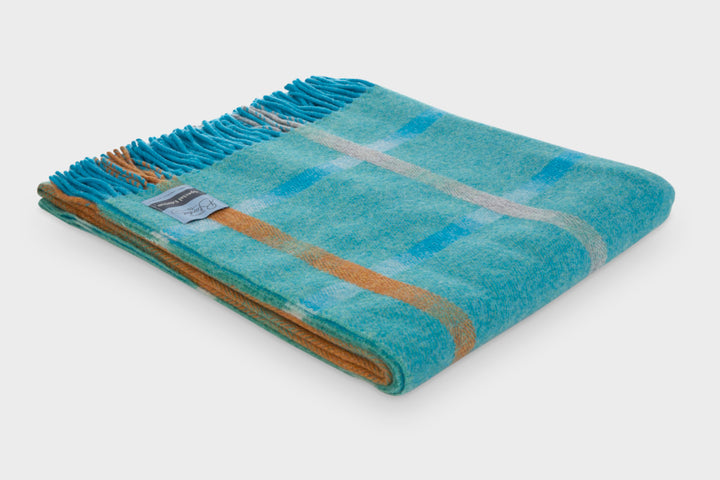 Folded blue and yellow checked lambswool throw by The British Blanket Company