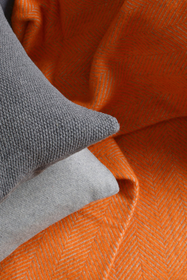 Closeup of XL orange and grey herringbone wool throw
