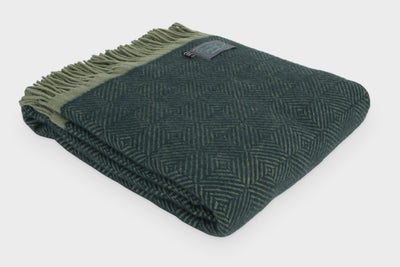 Folded green wool throw by The British Blanket Company