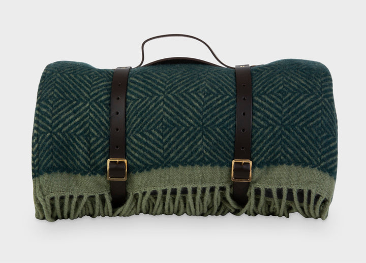 Green wool picnic blanket with leather straps from The British Blanket Company