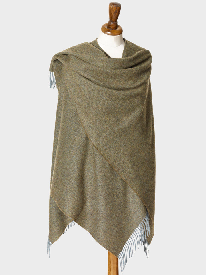 Green wearable lambswool blanket wrap on a mannequin