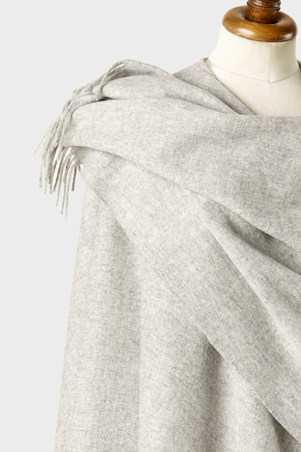Closeup of light grey wearable wool blanket wrap wrapped on mannequin