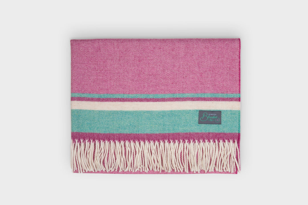 Folded pink and blue merino lambwool baby blanket by The British Blanket Company