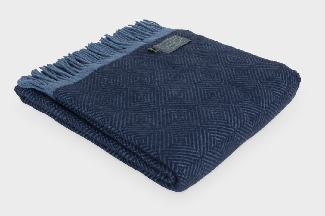 Folded dark blue wool throw by The British Blanket Company
