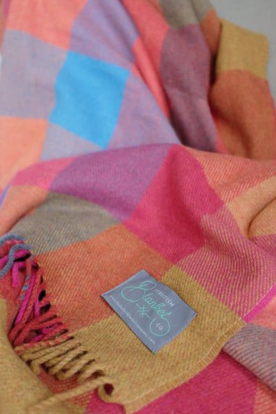 Closeup of large multicoloured check wool throw by The British Blanket Company