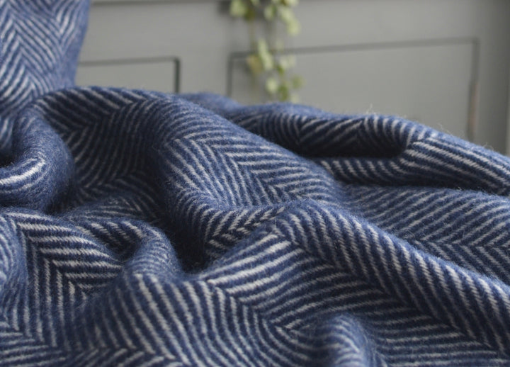 Closeup of a navy blue herringbone wool throw by The British Blanket Company