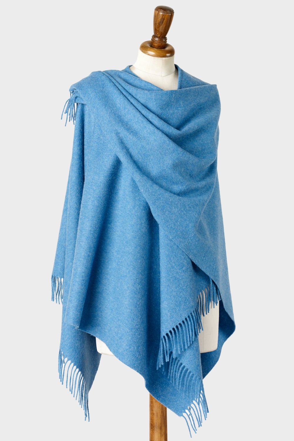 Light blue wearable merino lambswool blanket wrap on a mannequin