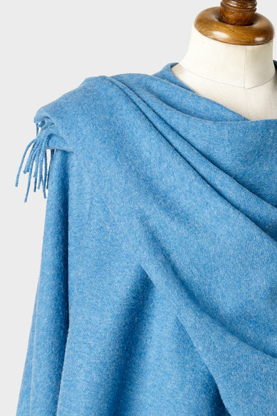 Closeup of light blue wearable lambswool blanket wrap on a mannequin