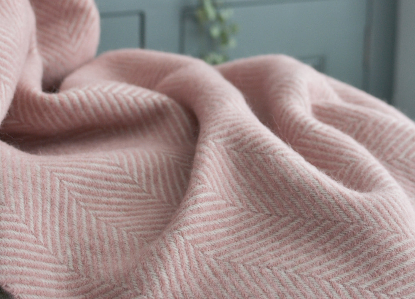 Closeup of pink herringbone wool throw by The British Blanket Company.